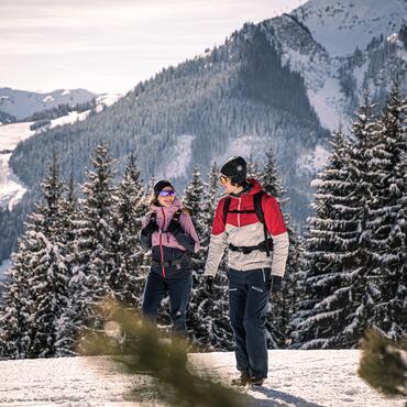 couple winter hiking in Saalbach